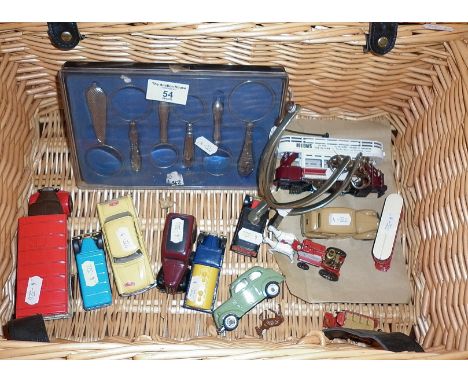 Hamper containing decorative handled magnifying glasses, pair of spurs and several modern Corgi and other diecast vehicles
