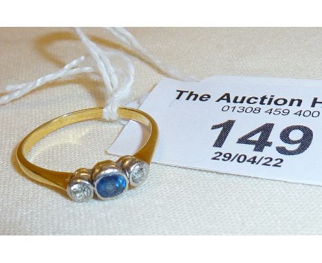 Gold ring set with diamonds and sapphire, approx. UK size N and weight 2g.