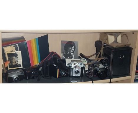 Canon AE-1 camera kit, a Polaroid Super Colour Swinger III and three other cameras
