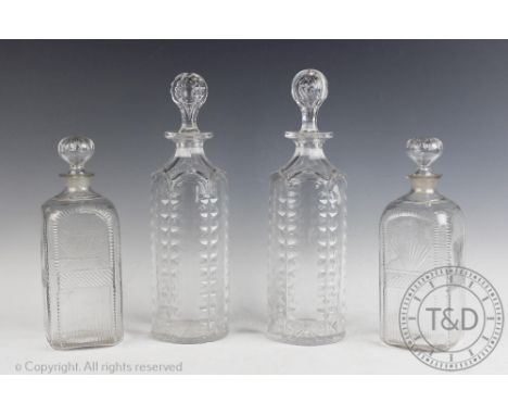 A pair of Victorian cylindrical decanters and stoppers, each with oval cut faceted detail, 30cm high and a pair of early 19th