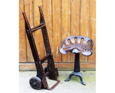 A cast metal implement seat, on associated stand, 53.5cm H, with a vintage sack truck (2)