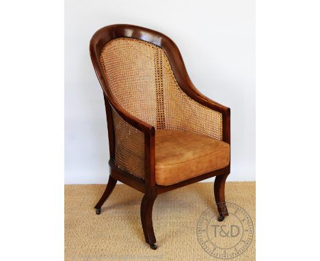 A Regency mahogany caned tub chair, on sabre legs, 106.5cm H CONDITION REPORT: The top of the frame has an old repaired break