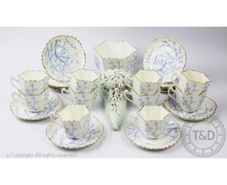A Victorian Aesthetic part tea service, decorated with prunus flowers, with a floral encrusted wall pocket, 20.5cm
