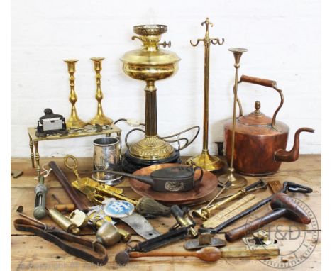 A collection of brass and copper items, to include; an oil lamp, a kettle, with other tools and treen items including rulers 