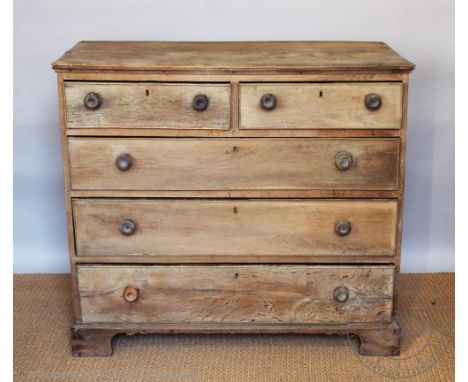 An early 19th century oak chest, of faded appearance, with two short and three long drawers, on bracket feet, 103cm H x 114cm