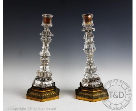 A pair of 19th century ormolu and cut glass candlesticks, of hexagonal form with sectional stems and faceted detailing, 34.5c