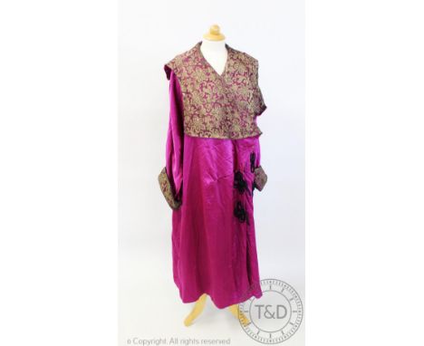 A magenta evening coat, circa 1920s, the silk coat with gilt metallic lace inserts to the collar and cuffs, black piping deta