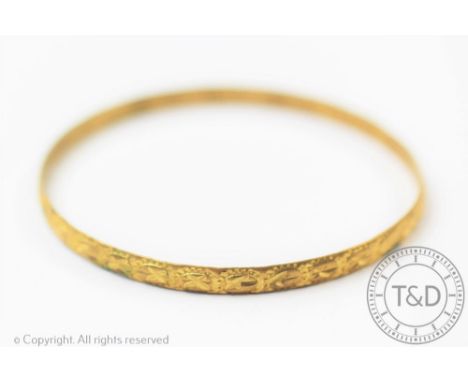 A yellow metal bangle stamped '22ct', 6.5cm wide, 7 grams  