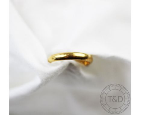 A 22ct gold wedding band, incised to the interior, size K, gross weight 3.73gms 