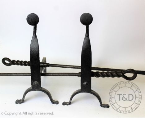 A pair of Arts and Crafts style cast iron fire dogs, with two fire tools with entwined handles, one poker 88cmProvenance: Yea
