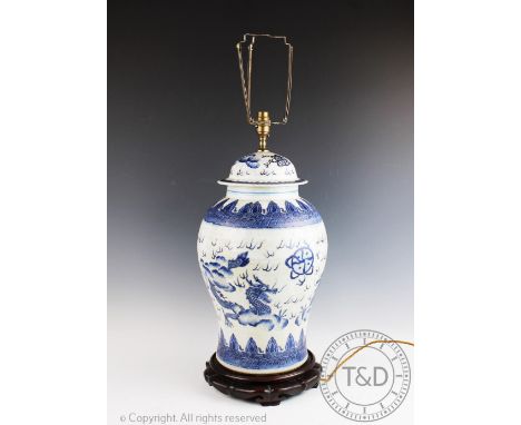 A Chinese porcelain lamp, modelled as a vase and cover, on carved hard wood stand, 59cm high (At fault) CONDITION REPORT: Lig