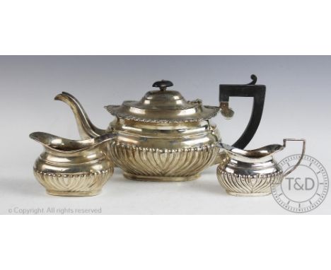 An assembled silver bachelors tea service, comprising; a teapot, Birmingham 1926, 14.5cm high, a sugar bowl, Sheffield 1903, 