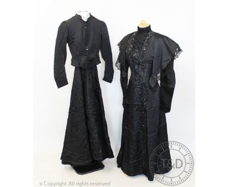 A black satin beaded bodice, with lace inserts and high collar neckline, circa 1900, with a black jacket with button front, l