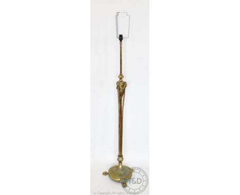 An Edwardian brass adjustable standard lamp in the Adam style, with circular base and paw shaped feet, 131cm H CONDITION REPO