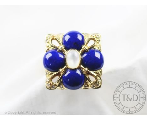 A lapis lazuli, moonstone and diamond set yellow gold ring in Boucheron style, designed as a flower head with four lapis lazu