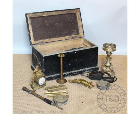 A 19th century stained pine trunk, enclosing a selection of metal ware items, including two oil cans, a clock, finger plates 