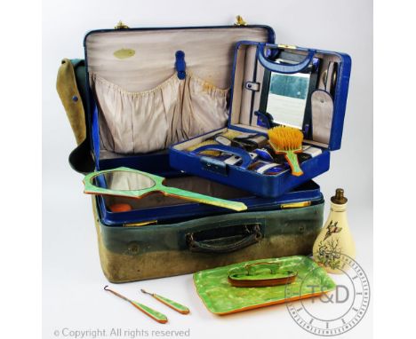 An Art Deco blue enamel travelling vanity case, within a larger travelling case, the vanity case enclosing a dressing table m