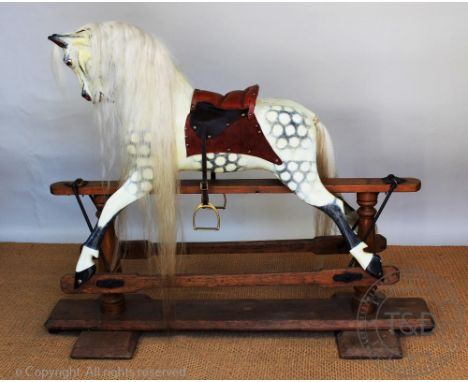 An Ayres type dappled rocking horse, with replacement leather saddle, on pine stand, 114cm to the top of the ears CONDITION R
