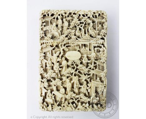 A 19th century Cantonese carved ivory calling card case, profusely decorated with figures and pagodas, 12cm (hair line crack 