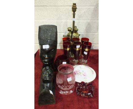 Two hardwood native heads, a brassed figural table lamp and a small collection of glassware etc.