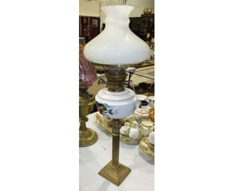 A late-19th century oil lamp, the white opaque glass reservoir painted with fruit and leaves, on brass Corinthian column and 