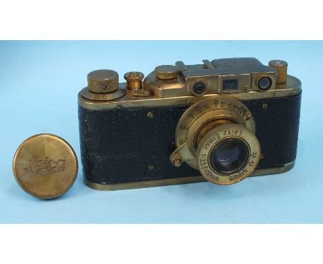 A Russian copy of a Leica camera with brass case, numbered 109264.