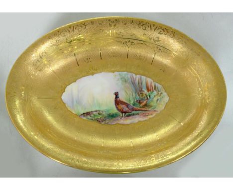 A ROYAL WORCESTER GILT GROUND OVAL DISH, PAINTED BY M. MORRIS, SIGNED, WITH PHEASANTS, THE FOOTRIM GILT 26CM W, GILT PRINTED 