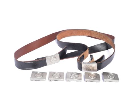 A collection of vintage East German / DDR National Peoples Army belts and buckles. The buckles featuring a hammer and compass