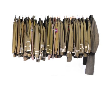 A large collection of WWI First World War reenactment British Military uniform tunics. Various ranks and regiments to include