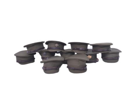 A collection of re-enactment WWII Second World War British Army Officers peak hat visors. All with brown leather chin straps,