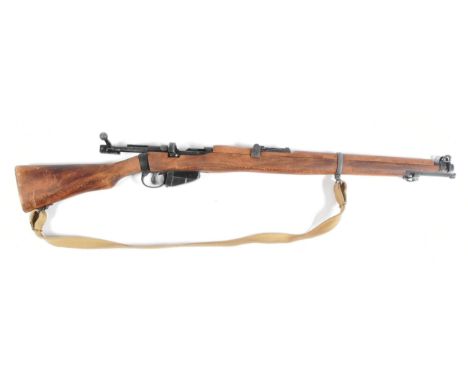 A replica WWI First World War British 1914 Enfield style bolt action rifle. Dog leg style stock, integrated faux magazine and