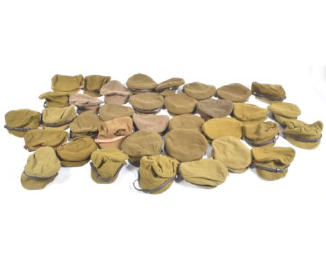 A large collection of re-enactment WWI First World War British Army trench caps with leather chin straps and brass buttons.