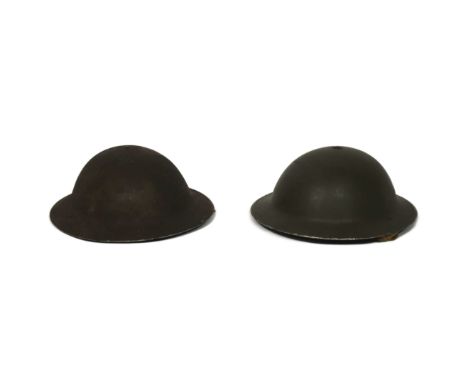 Two WWII Second World War British Army Brodie helmets. Both dated 1940 and retaining liners and chin straps.