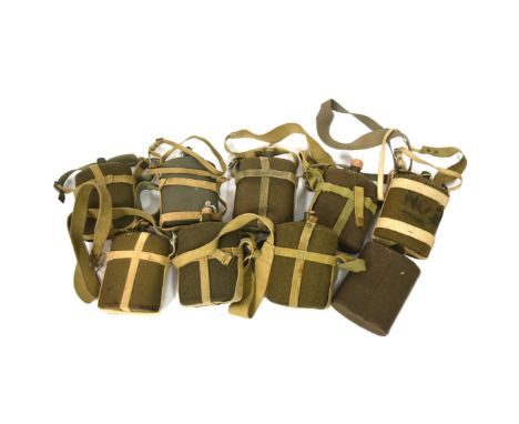 A collection of x9 WWI First World War British Army water bottle canteens. All with felt coverings, webbing straps and some r