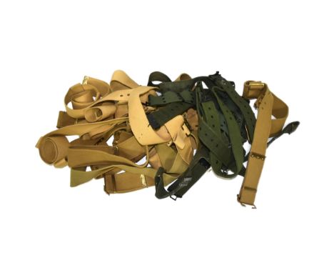 A large collection of British Military uniform webbing belts. Desert tan and khaki examples, largely unmarked / surplus. A fe