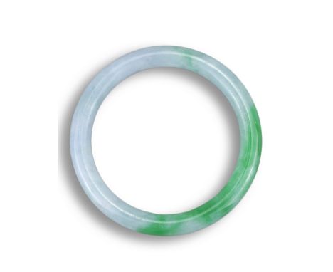 A JADEITE BANGLE. Bright green and white in tone. Together with Jade Identification Certificate dated 1 August 2011, No. KH47