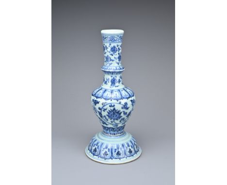 A CHINESE BLUE AND WHITE PORCELAIN CANDLESTICK. Of baluster form with a domed base decorated with bands of chrysanthemum scro