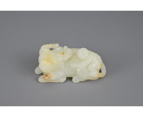 A CHINESE PALE CELADON JADE CARVING OF WATER BUFFALO. The boy climbing onto the buffalos back grabbing its horn. 6.5cm length