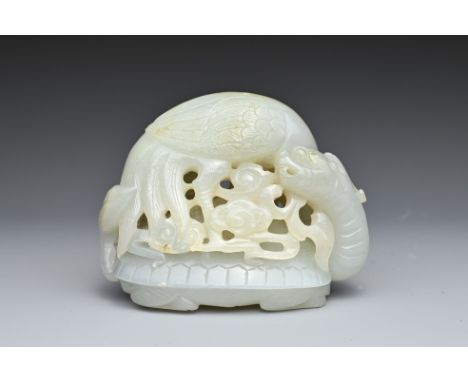 A CHINESE PALE CELADON JADE CARVING. Pierced and carved with a crane holding a branch in its beak with ruyi heads standing on