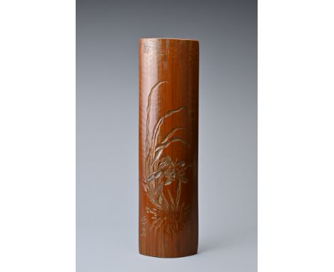 A CHINESE BAMBOO WRIST REST, QING DYNASTY, 18TH CENTURY. Glossy brown convex bamboo section carved with orchid flower. Signat