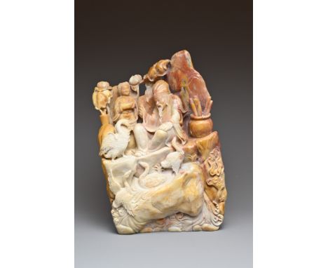 A CHINESE SOAPSTONE BOULDER. Carved in deep relief depicting a calligrapher with boy and geese in landscape scene. 24.5cm tal