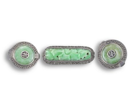 A CHINESE SILVER JADEITE BROOCH WITH CLIPS, 20TH CENTURY. The carved jadeite lotus leaf group mounted in a silver filigree mo