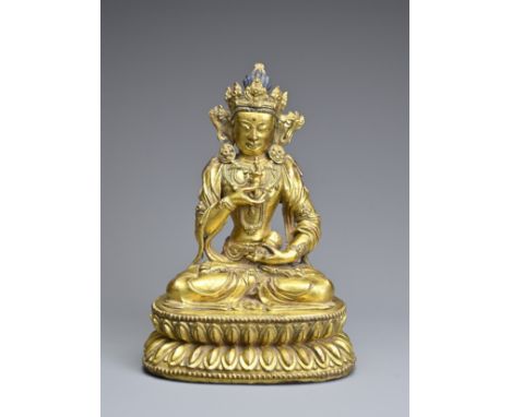A CHINESE GILT BRONZE FIGURE OF VAJRASATTVA, INCISED XUANDE MARK. The figure seated in dhyanasana on a double lotus base hold