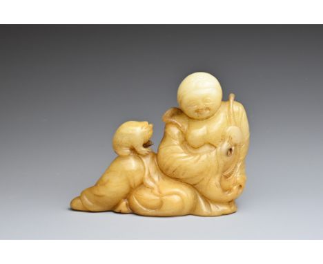 A CHINESE JADE CARVING OF LIU HAI AND TOAD. The figure reclining holding a cash coin and the toad on his knee. 11cm length x 