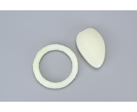 TWO CHINESE PALE CELADON JADE ITEMS. To include a round bamboo form bangle together with an uncarved jade pebble. Bangle 8cm 