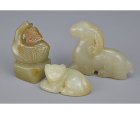 THREE CHINESE CARVED CELADON JADE ITEMS. Comprising a celadon jade seal in the form of a goose holding a lotus branch; A pale