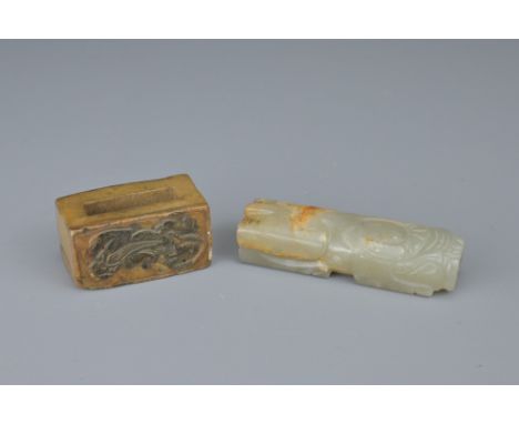 TWO CHINESE JADE FITTINGS. To include a celadon and russet animal form section of cylindrical form. Together with a brown jad