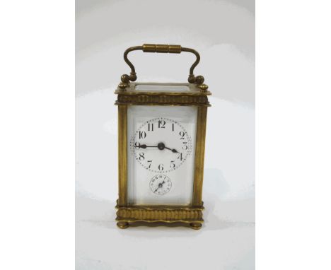 A brass cased carriage clock, with enamel dial and subsidiary alarm dial, striking on a bell, 3.5cm high, including handle