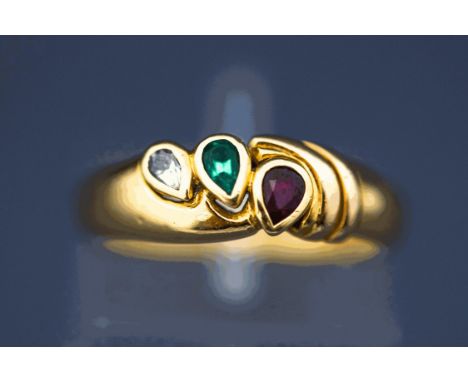 A three stone diamond, emerald and ruby ring, stamped '750', finger size L, 4.6 gross