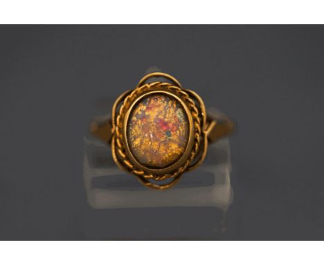 A 9 carat gold ring set with a simulated opal, finger size N, 3g gross